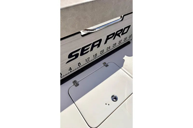 Slide: The Image of 2024 Sea Pro 242 boat deck with measurement markings and storage compartment. - 20
