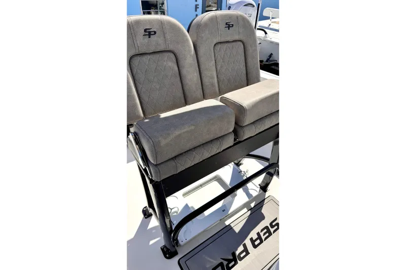 Slide: The Image of 2024 Sea Pro 242 boat seats with gray upholstery and diamond stitching. - 6