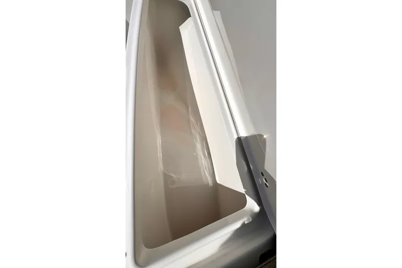 Slide: The Image of 2024 Sea Pro 242 boat storage compartment, white interior, angled view. - 8
