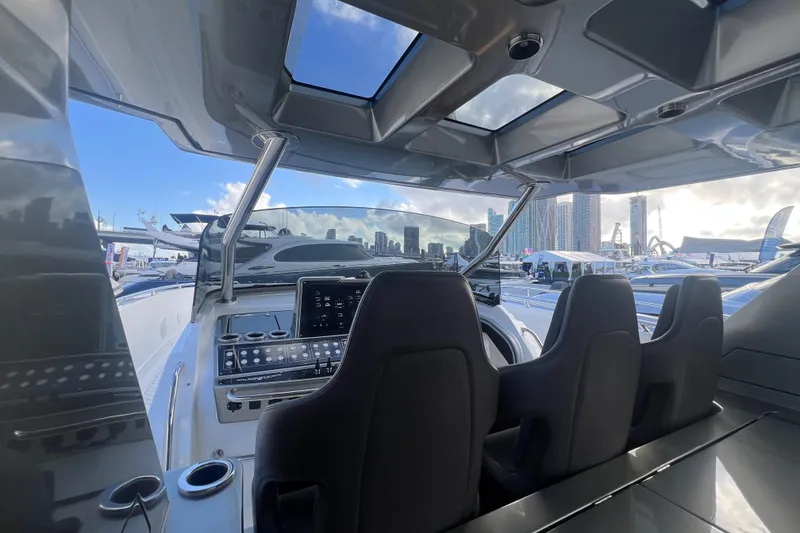 Slide: The Image of Interior view of 2023 Canados 493 Gladiator yacht cockpit with modern controls and city skyline. - 11