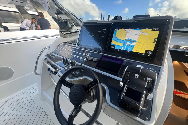 Slide: The Image of 2023 Canados 493 Gladiator yacht helm with advanced navigation displays and controls. - 15