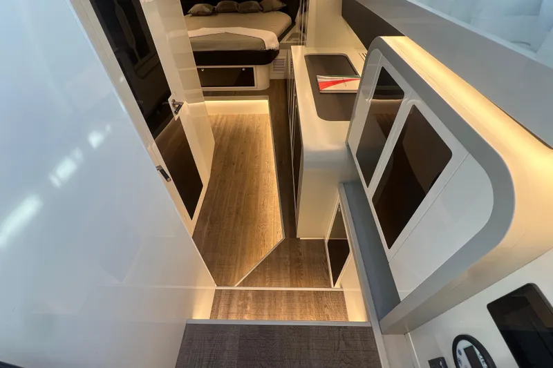 Slide: The Image of 2023 Canados 493 Gladiator interior with modern design, wood flooring, and ambient lighting. - 22