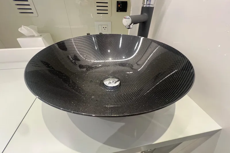 Slide: The Image of Carbon fiber sink in a modern bathroom on the 2023 Canados 493 Gladiator yacht. - 32