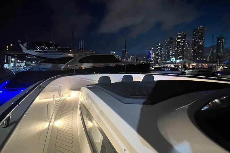 Slide: The Image of 2023 Canados 493 Gladiator yacht at night with city skyline backdrop. - 35
