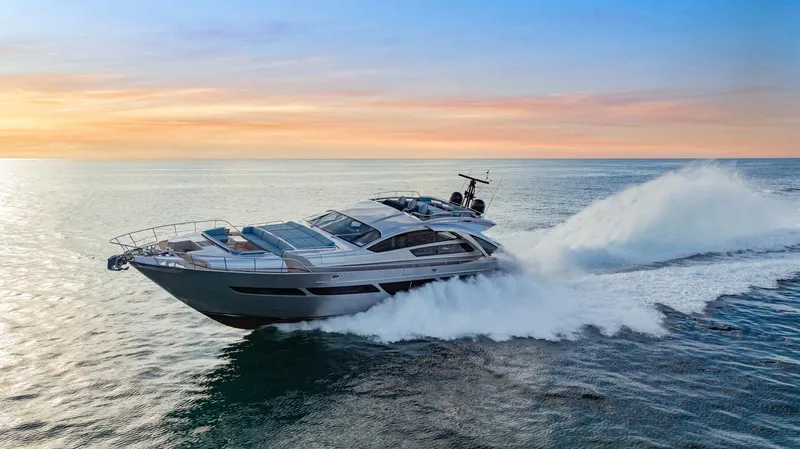 Slide: The Image of 2021 Pershing 9X yacht cruising at sunset on open water. - 2