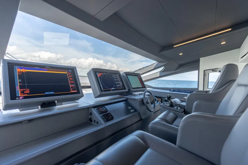 Slide: The Image of Luxurious 2021 Pershing 9X yacht cockpit with advanced navigation displays and plush seating. - 20