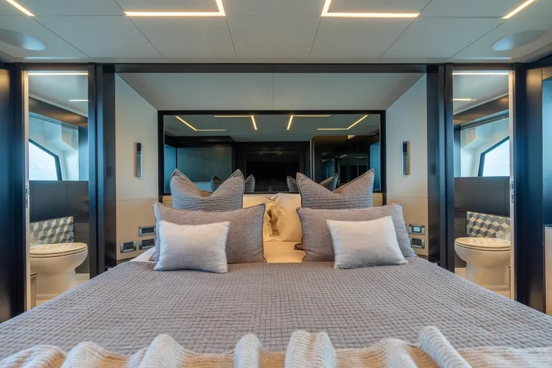 Slide: The Image of Luxurious bedroom interior on 2021 Pershing 9X yacht, featuring elegant bedding and modern design. - 24