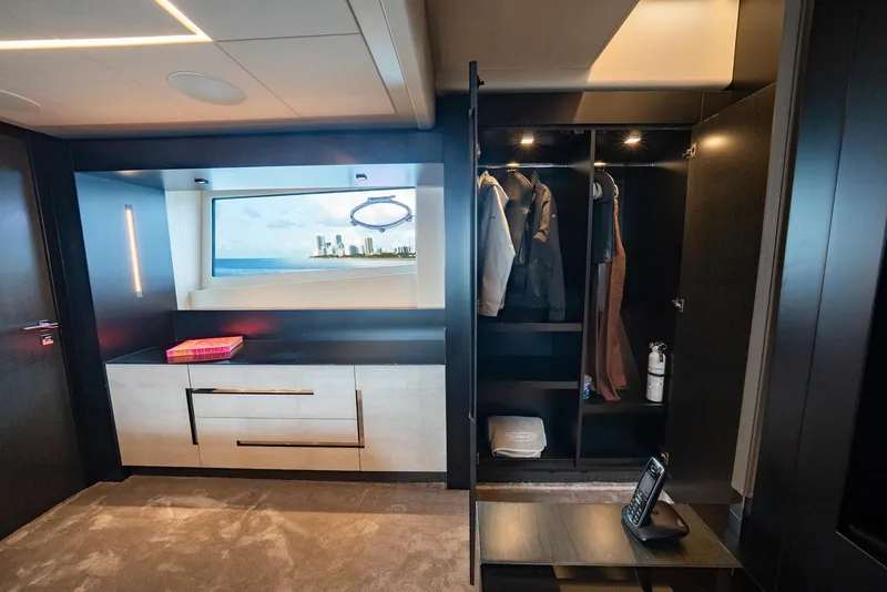 Slide: The Image of Luxurious interior of 2021 Pershing 9X yacht with wardrobe and ocean view window. - 25
