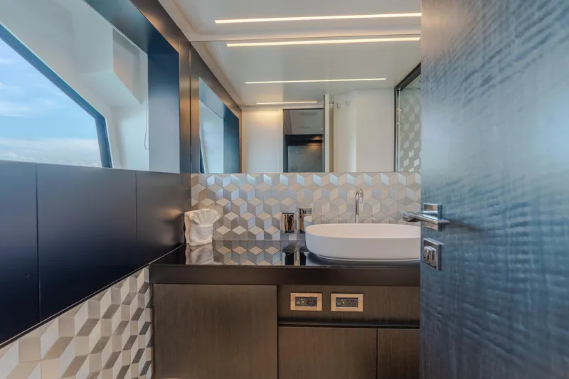 Slide: The Image of Luxurious bathroom interior on 2021 Pershing 9X yacht, featuring modern sink and geometric tiles. - 26