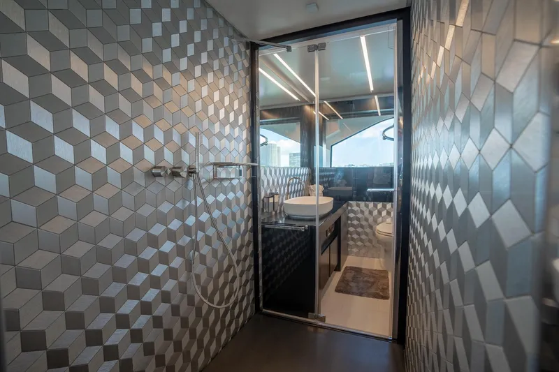 Slide: The Image of Luxurious bathroom in 2021 Pershing 9X yacht with geometric wall tiles and modern fixtures. - 27