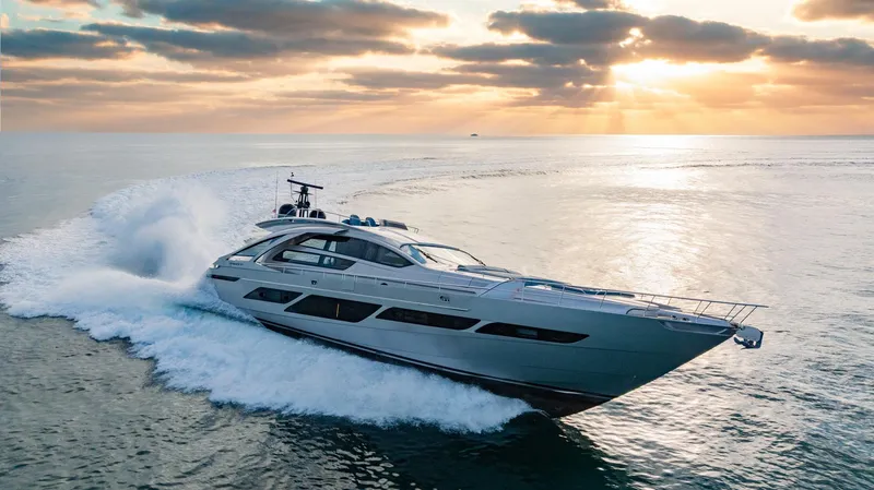 Slide: The Image of 2021 Pershing 9X yacht cruising at sunset on open water. - 3