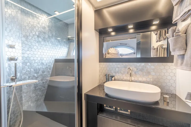 Slide: The Image of Luxurious bathroom in 2021 Pershing 9X yacht with modern hexagonal tile design. - 30