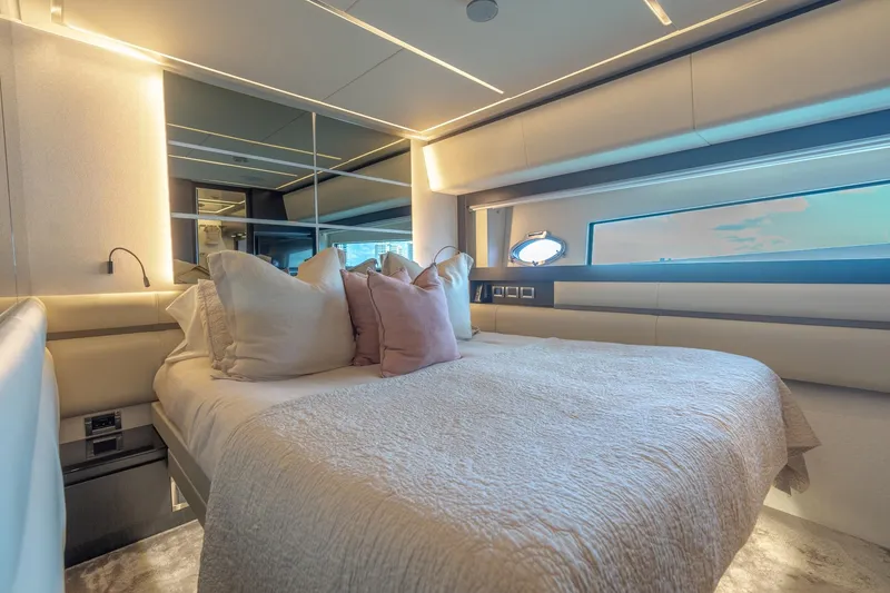 Slide: The Image of Luxurious bedroom interior of 2021 Pershing 9X yacht with modern design and plush bedding. - 31