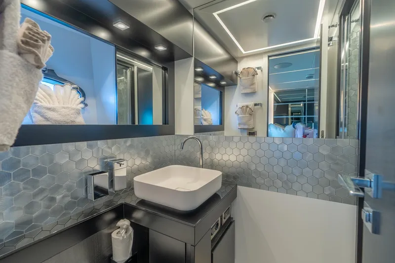 Slide: The Image of Luxurious bathroom in 2021 Pershing 9X yacht with modern fixtures and hexagonal tile design. - 32