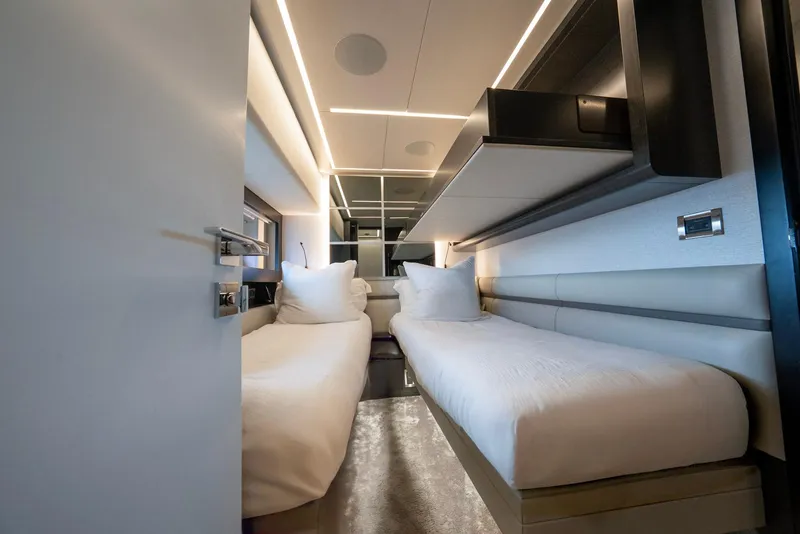 Slide: The Image of Luxurious twin cabin interior on 2021 Pershing 9X yacht, featuring modern design and ambient lighting. - 33
