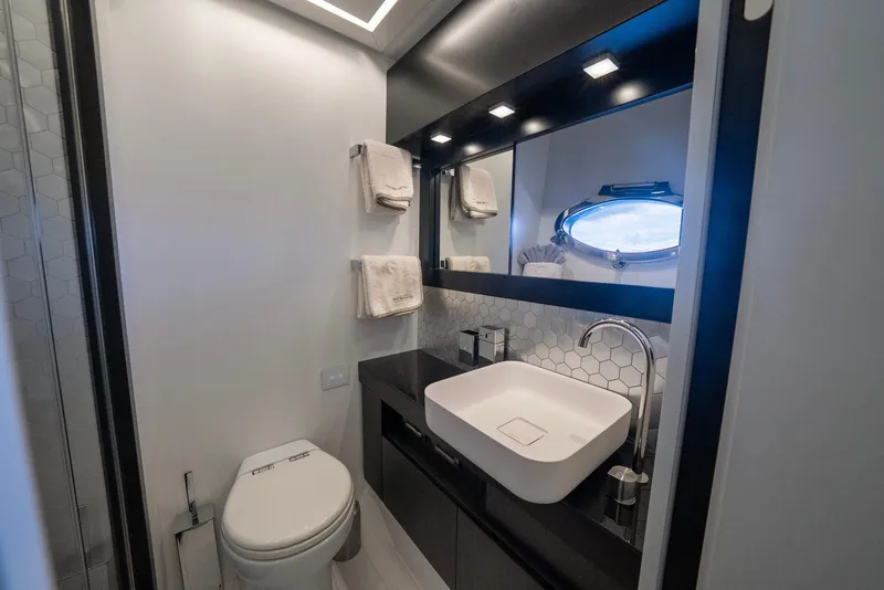 Slide: The Image of Luxurious bathroom in 2021 Pershing 9X yacht with modern fixtures and porthole window. - 35