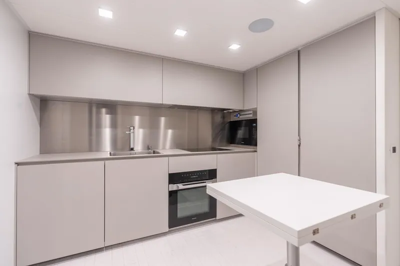 Slide: The Image of Modern kitchen interior on 2021 Pershing 9X yacht, featuring sleek cabinetry and stainless steel appliances. - 36