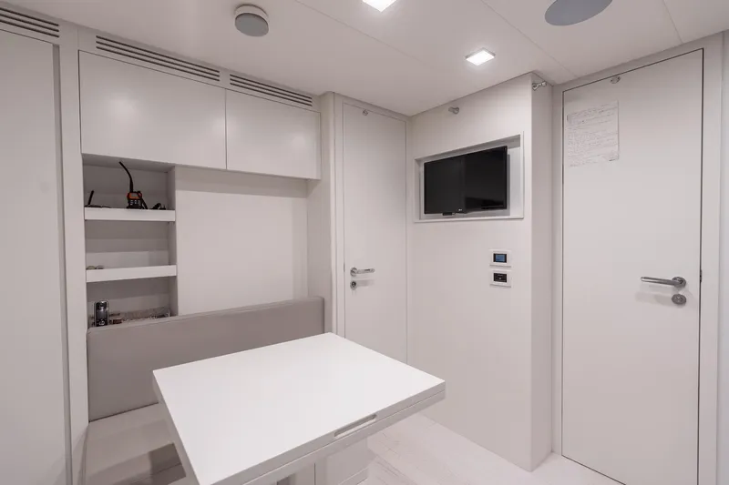Slide: The Image of Modern interior of 2021 Pershing 9X yacht with sleek white furnishings and compact design. - 37