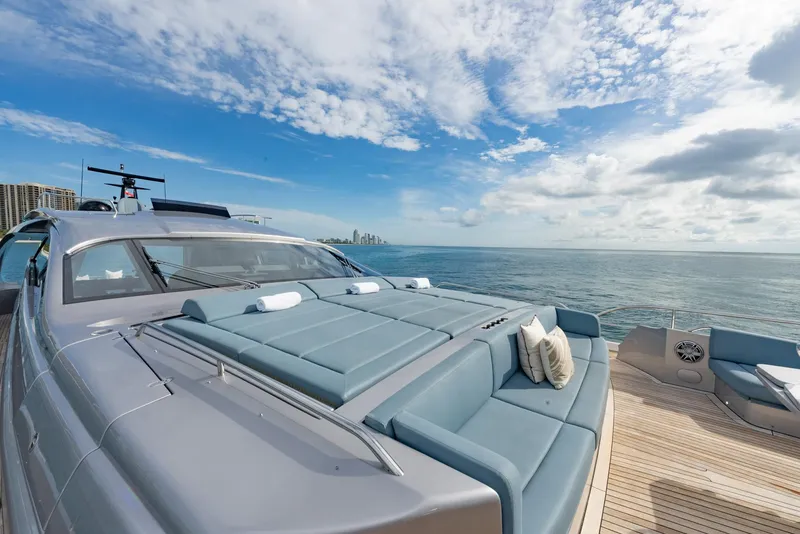 Slide: The Image of Luxury Pershing 9X yacht deck with sun loungers, ocean view, and blue sky, 2021 model. - 46