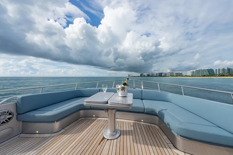 Slide: The Image of Luxurious 2021 Pershing 9X yacht deck with ocean view, featuring elegant seating and champagne. - 47