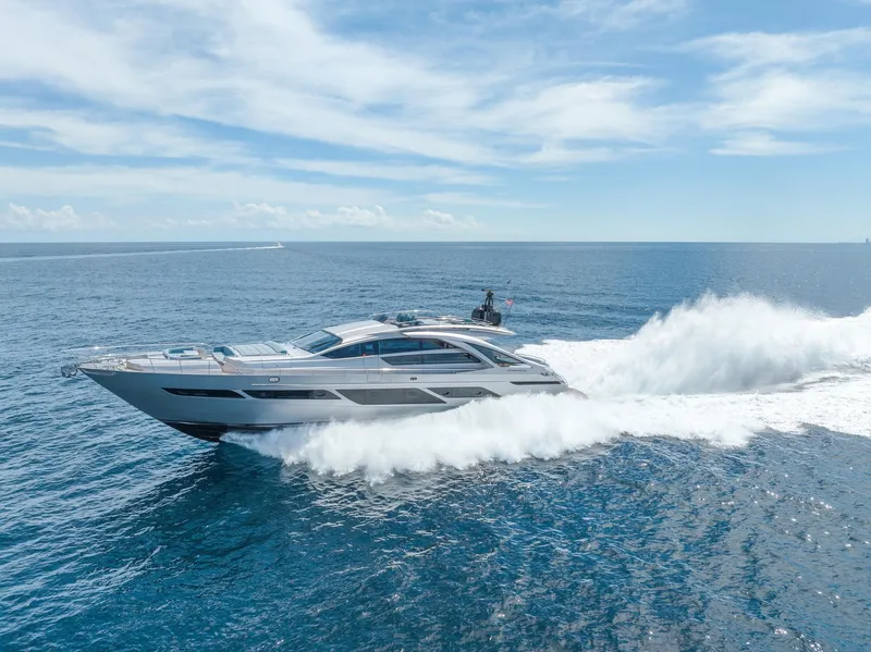 Slide: The Image of 2021 Pershing 9X yacht cruising on open sea under clear blue sky. - 5