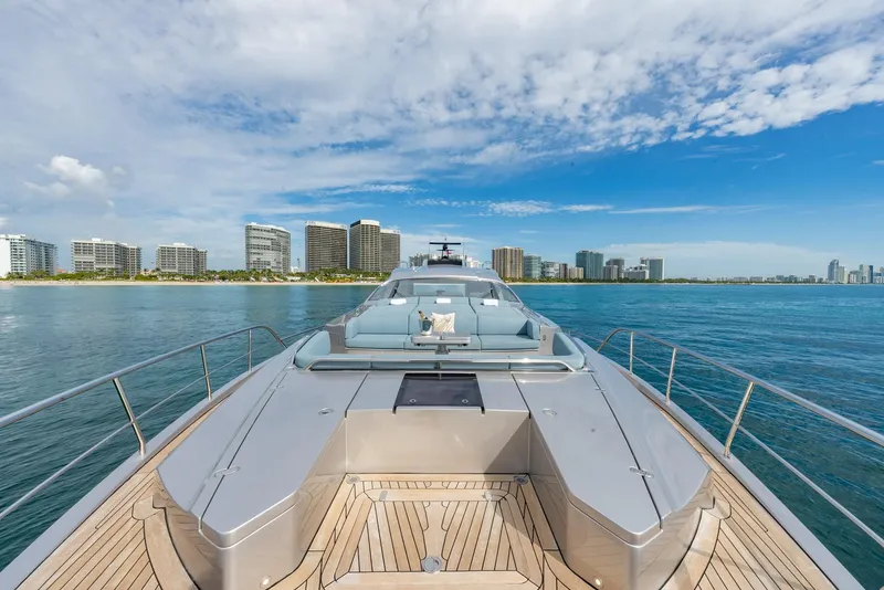 Slide: The Image of Luxurious 2021 Pershing 9X yacht cruising near a city skyline under a blue sky. - 50