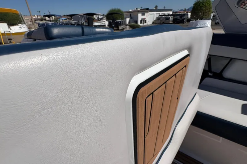 Slide: The Image of 2018 Nautique Super Air Nautique G25 interior detail with white upholstery and wood accent. - 11