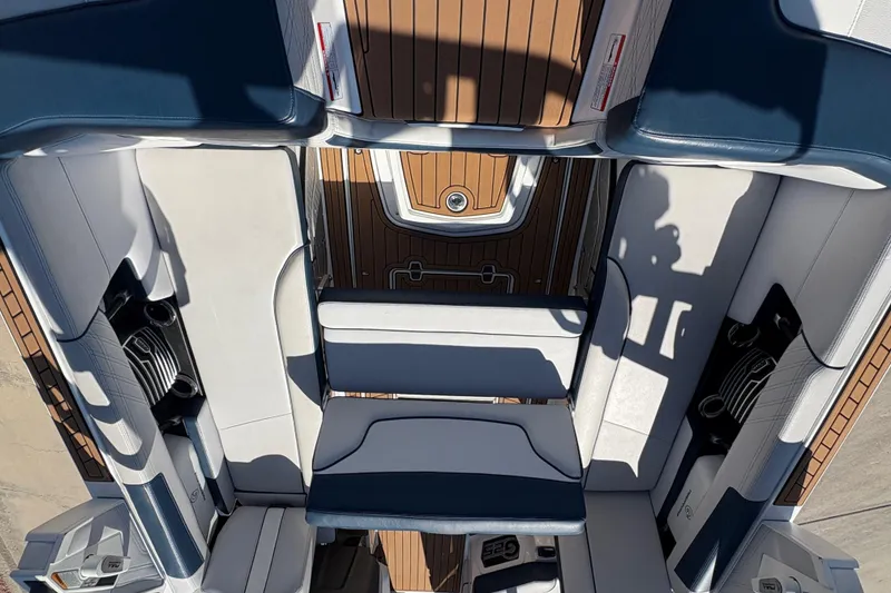 Slide: The Image of 2018 Nautique Super Air Nautique G25 interior with luxurious seating and teak flooring. - 12