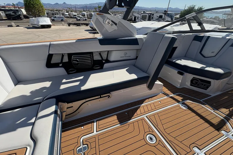 Slide: The Image of 2018 Nautique Super Air Nautique G25 interior with luxurious seating and teak-style flooring. - 13