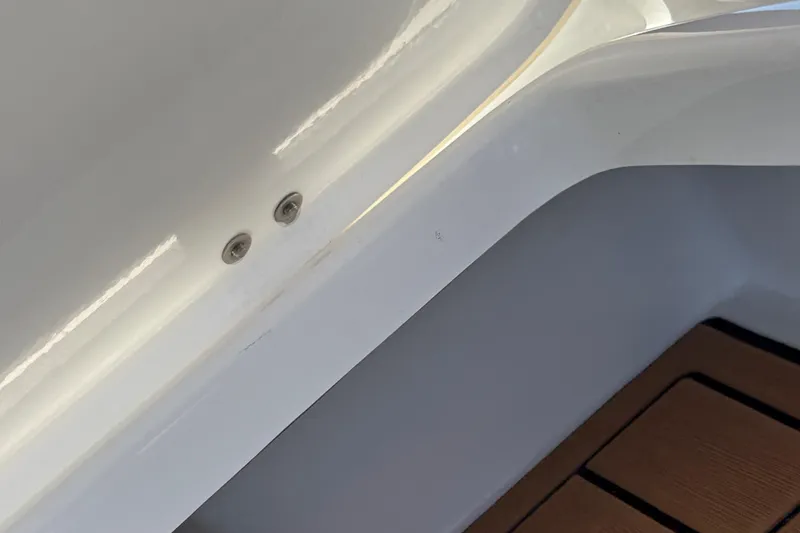 Slide: The Image of Interior detail of 2018 Nautique Super Air Nautique G25 boat, featuring sleek white finish. - 14