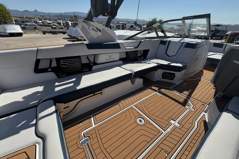 Slide: The Image of 2018 Nautique Super Air Nautique G25 interior with luxurious seating and teak-style flooring. - 19