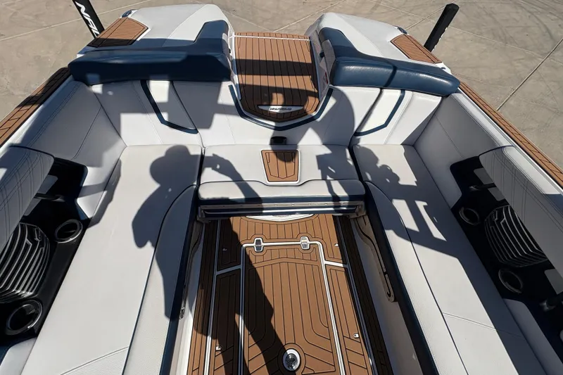 Slide: The Image of Interior of 2018 Nautique Super Air Nautique G25 boat with white and brown seating. - 20