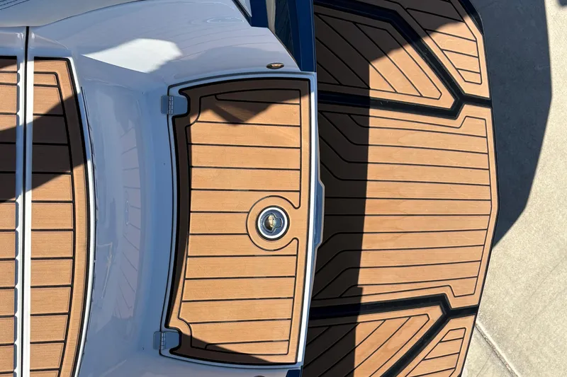 Slide: The Image of 2018 Nautique Super Air Nautique G25 boat deck with wood finish and sleek design. - 21