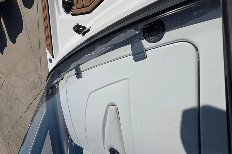 Slide: The Image of 2018 Nautique Super Air Nautique G25 boat deck with wood accents and windshield. - 22