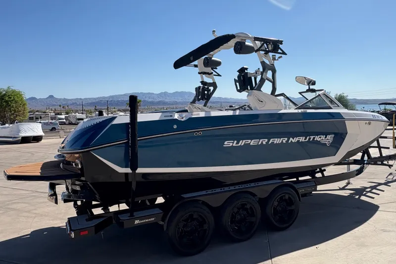 Slide: The Image of 2018 Nautique Super Air Nautique G25 boat on trailer, parked outdoors. - 3