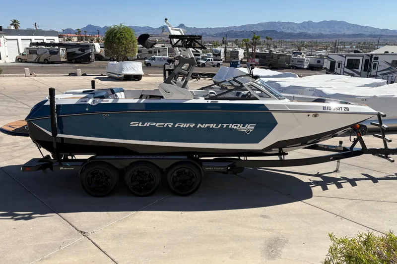 Slide: The Image of 2018 Nautique Super Air Nautique G25 boat on trailer, parked outdoors. - 4