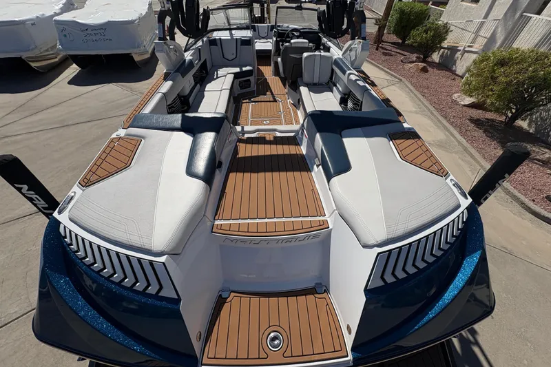 Slide: The Image of 2018 Nautique Super Air Nautique G25 boat interior with sleek seating and wood accents. - 7