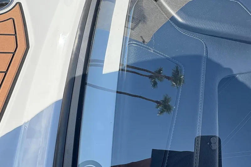 Slide: The Image of 2018 Nautique Super Air Nautique G25 boat interior with palm tree reflection on window. - 8