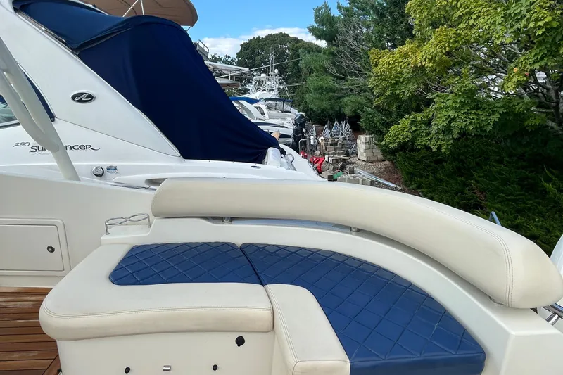 Slide: The Image of 2016 Chris-Craft Launch 36 boat with blue and white seating, docked near greenery. - 10