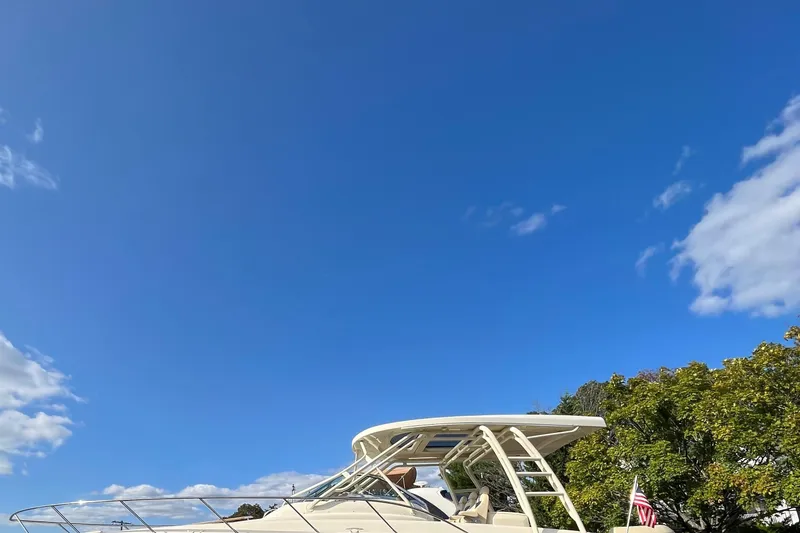 Slide: The Image of 2016 Chris-Craft Launch 36 boat under clear blue sky with trees in the background. - 2