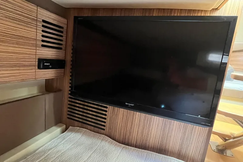 Slide: The Image of 2016 Chris-Craft Launch 36 interior with Sharp TV and wood paneling. - 20
