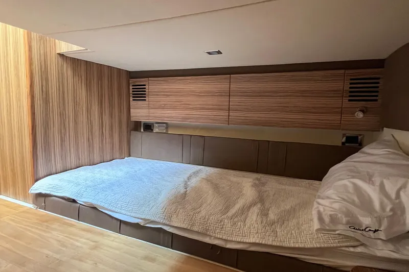 Slide: The Image of 2016 Chris-Craft Launch 36 cabin interior with wooden paneling and cozy bedding. - 21