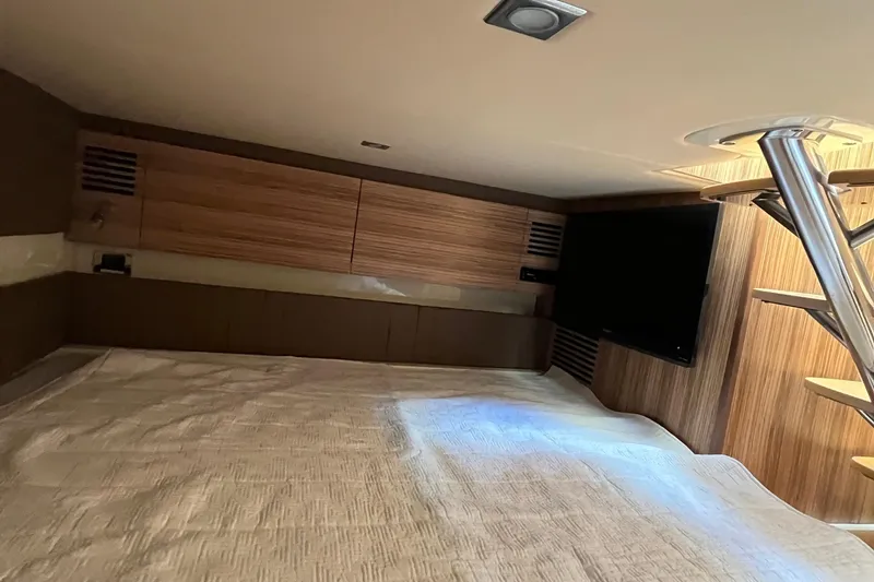 Slide: The Image of Luxurious interior cabin of 2016 Chris-Craft Launch 36 with wood paneling and TV. - 22