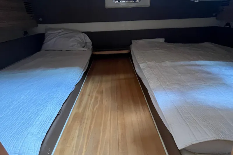 Slide: The Image of 2016 Chris-Craft Launch 36 cabin interior with twin beds and wooden flooring. - 25