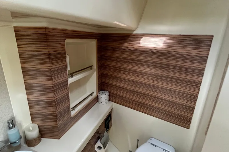 Slide: The Image of 2016 Chris-Craft Launch 36 bathroom with wood paneling and modern fixtures. - 26
