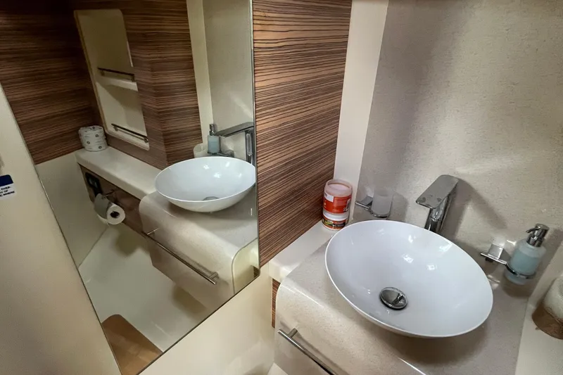 Slide: The Image of 2016 Chris-Craft Launch 36 bathroom with modern sink and wood accents. - 27
