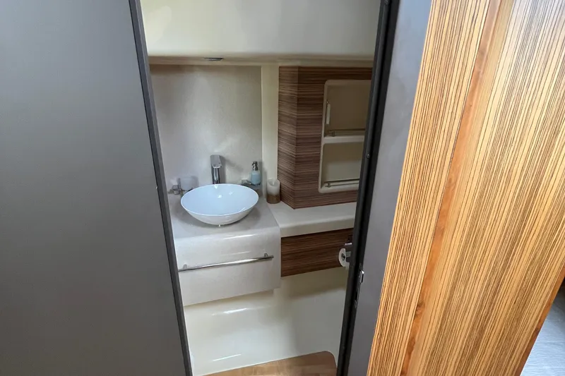 Slide: The Image of 2016 Chris-Craft Launch 36 bathroom interior with modern sink and wood accents. - 29