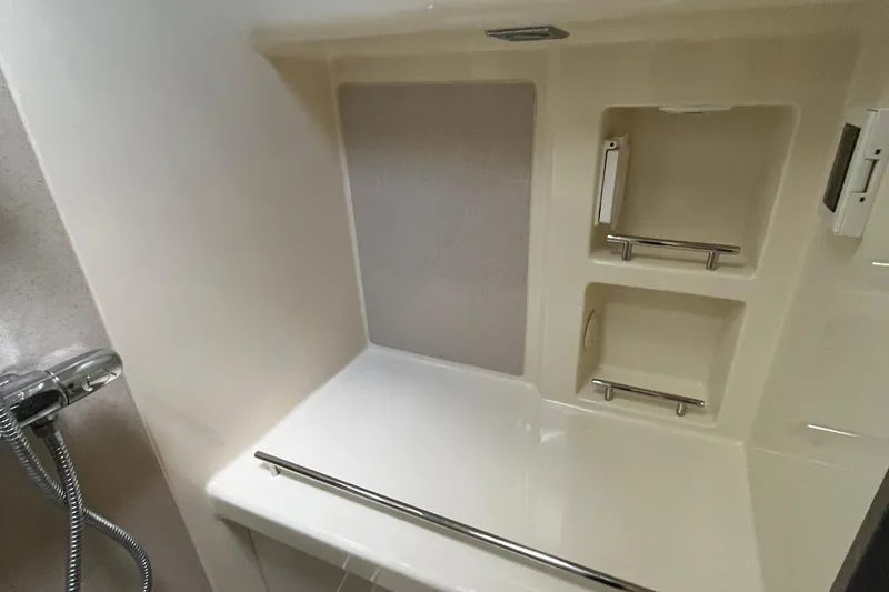 Slide: The Image of 2016 Chris-Craft Launch 36 bathroom with shower and storage shelves. - 30