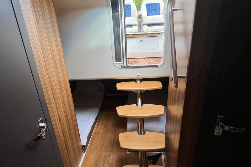 Slide: The Image of 2016 Chris-Craft Launch 36 interior with wooden steps and cabin view. - 32