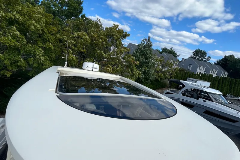 Slide: The Image of 2016 Chris-Craft Launch 36 boat with Garmin equipment, surrounded by trees and houses. - 39